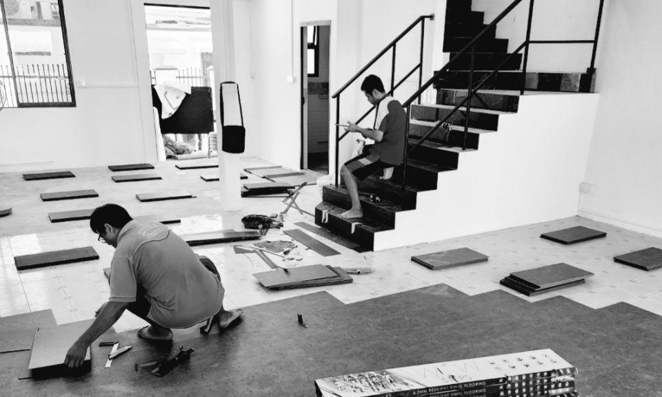 Workers laying Floor Tiles